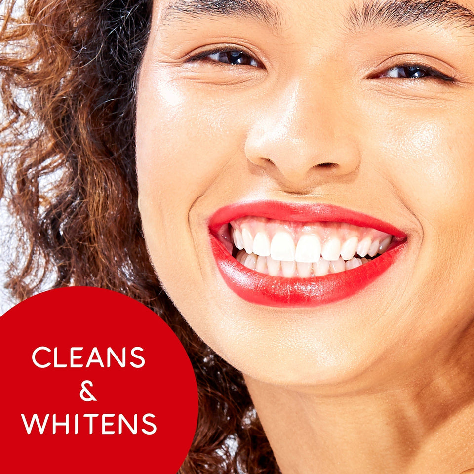 A woman with white teeth smiling. In text: Cleans & whitens.