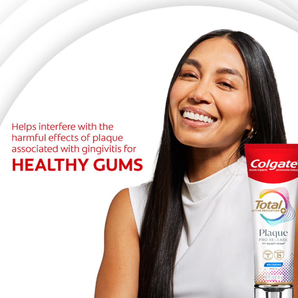 Woman smiling with a tube of Colgate Total Plaque Pro Release Whitening Toothpaste. In text: Helps interfere with the harmful effects of plaque associated with gingivitis for healthy gums.