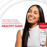 Woman smiling with a tube of Colgate Total Plaque Pro Release Whitening Toothpaste. In text: Helps interfere with the harmful effects of plaque associated with gingivitis for healthy gums.