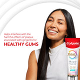 Woman smiling with a tube of Colgate Total Plaque Pro Release Fresh Mint Toothpaste. In text: Helps interfere with the harmful effects of plaque associated with gingivitis for healthy gums.