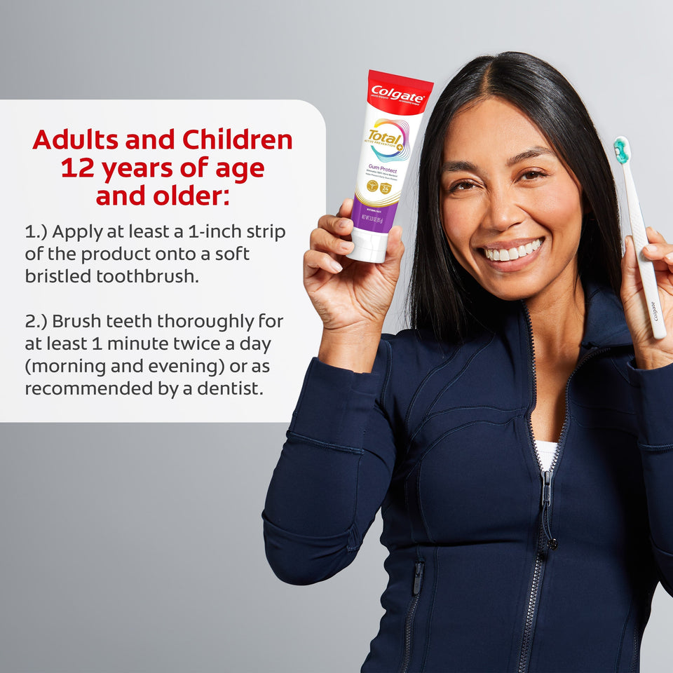 A woman smiling as she holds up a tube of Colgate Total Active Prevention Gum Protect Whitening Toothpaste and a toothbrush. In text: Adults and children 12 years of age and older: 1) Apply at least a 1-inch strip of the product onto a soft bristled toothbrush. 2) Brush teeth thoroughly for at least 1 minute twice a day (morning and evening) or as recommended by a dentist. 