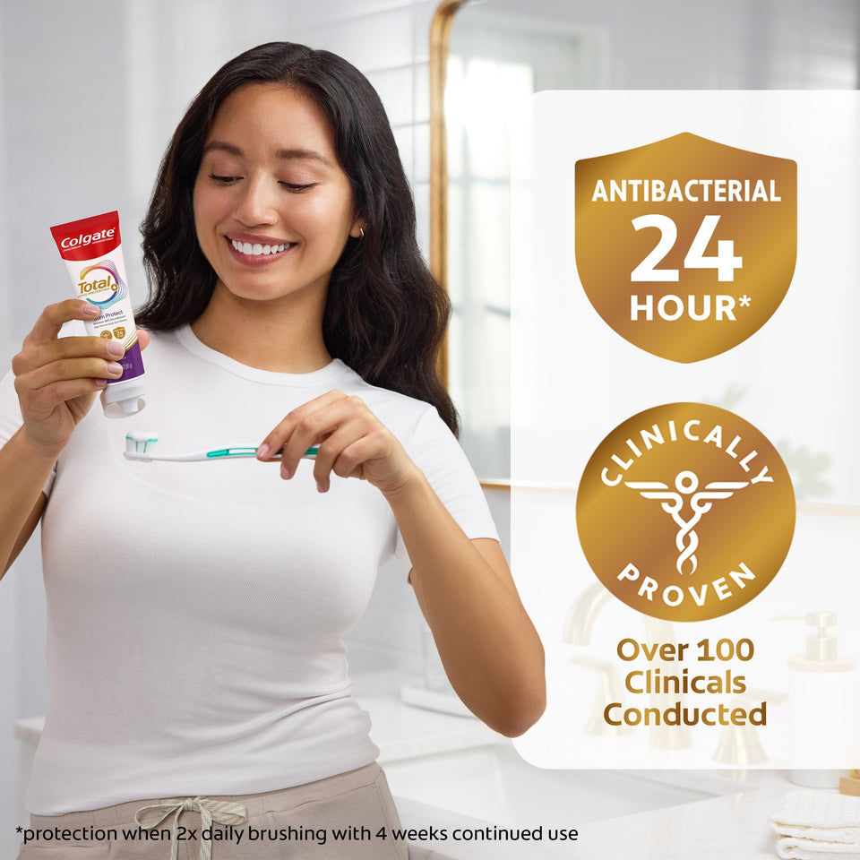 Woman holding Colgate Total Active Prevention Gum Protect Whitening Toothpaste toothpaste and a toothbrush. A shield badge icon with 'Antibacterial 24 Hour*' text inside. A medical badge icon with 'Clinically Proven' text inside. Below in text: Over 100 Clinicals Conducted. *protection when 2x daily brushing with 4 weeks continued use.