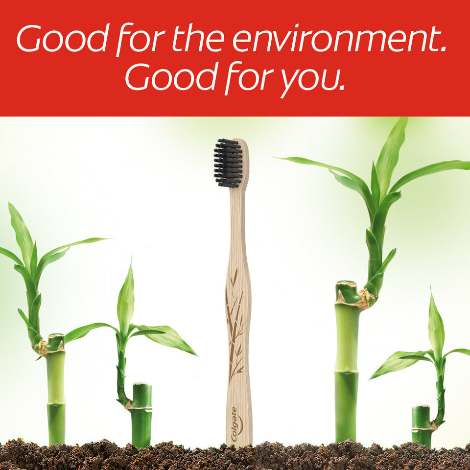 Colgate Bamboo Charcoal Manual Toothbrush with bamboo plants. In text: 'Good for the environment. Good for you.' 