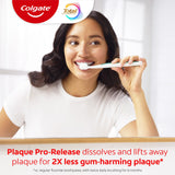 Woman brushing her teeth with Colgate Total Plaque Pro Release Toothpaste. In text: Plaque Pro-Release dissolves and lifts away plaque for 2X less gum-harming plaque* *vs. regular fluoride toothpaste, with twice daily brushing for 6 months.