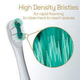 A close-up of the brush head on a white Colgate Total Battery Powered Toothbrush. In text: High Density Bristles for rapid foaming to clean hard to reach spaces